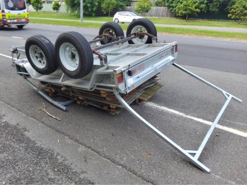 Trailer upside down on the road after an accident