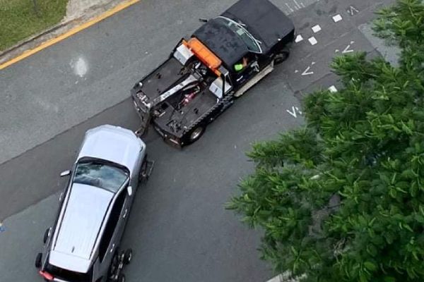 Car being towed from parking garage